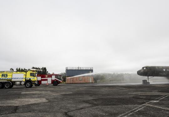 RNZAF and USAF firefighting vehicles conduct training on a fuselage