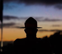 A soldier standing during Anzac Day commemoration. 