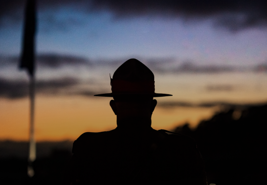 A soldier standing during Anzac Day commemoration. 