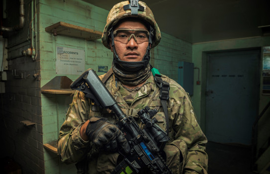 Corporal Nori Lee looks at the camera, fully equipped in operational gear.