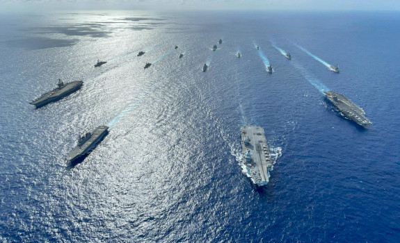 A fleet of Navy ships on the ocean