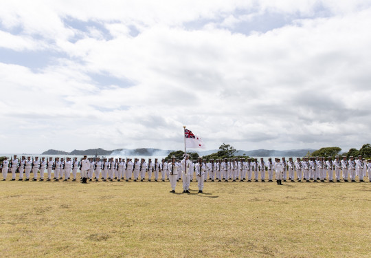 The Royal New Zealand Navy Royal Guard of Honour stands to attention as HMNZS Wellington conducts a 21-gun salute at the 2021 celebration.