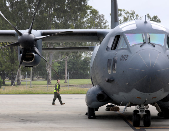 Royal Australian Air Force personnel conduct a final check of a C-27J Spartan aircraft headed to New Zealand to provide assistance following flooding caused by Tropical Cyclone Gabrielle.