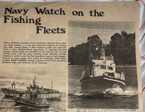 A historic newspaper clipping with the heading reading, 'Navy Watch on the Fishing Fleets'. It features three images of a Navy ship and a fishing vessel and an image of two Navy soldiers holding a sign with Japanese writing on it asking fishermen to 'move