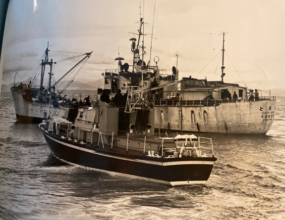 A photograph of a newspaper clipping of an image depicting a Navy ship intercepting a Japanese fishing vessel.