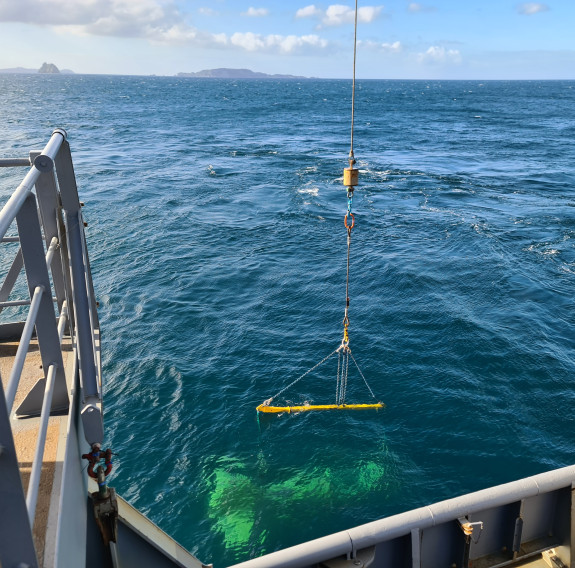 The plane staged on the seabed is lifted out of the sea and onto HMNZS Manawanui.