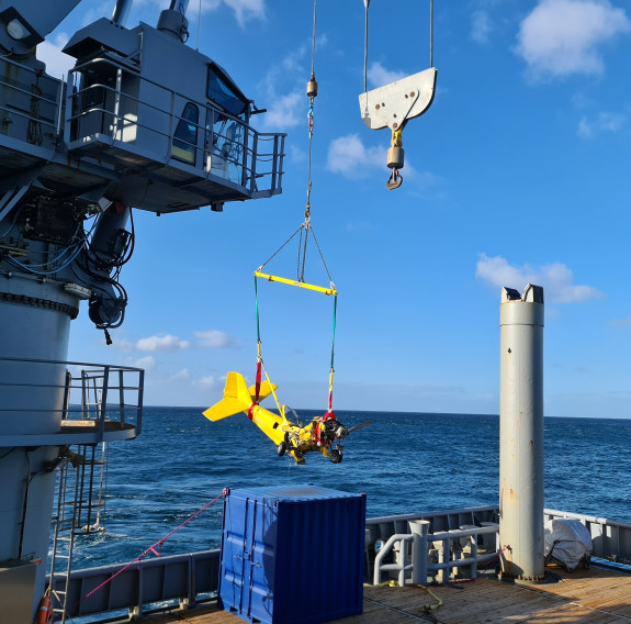 The plane staged on the seabed is lifted out of the sea and onto HMNZS Manawanui.