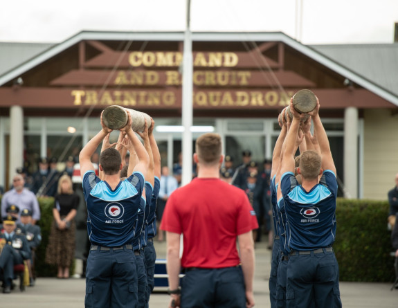 AIr Force recruits perform a physical routine in front of whānau and friends at their graduation. 