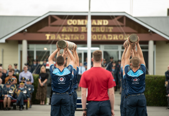 AIr Force recruits perform a physical routine in front of whānau and friends at their graduation. 