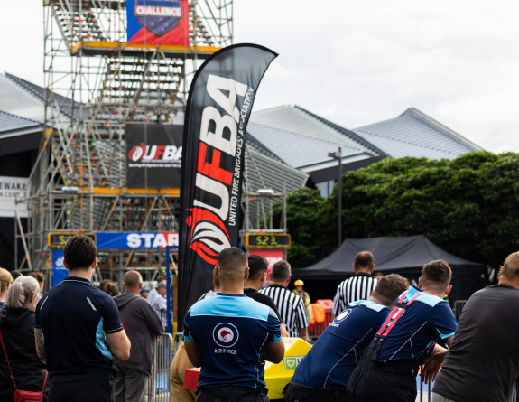 Air Force personnel watch the event at Odlins Plaza on the Wellington waterfront. A six storey set of stairs made of scaffolding is at one end of the course with UFBANZ branding on the side.