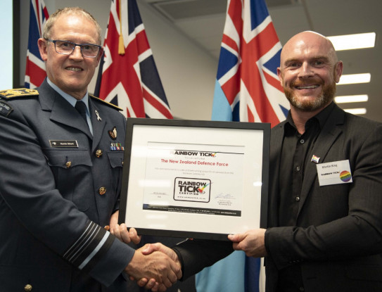 Chief of Defence Force Air Marshal Kevin Short and Brad Poultor with the NZDF Rainbow Tick certificate