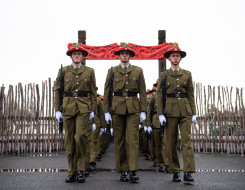 New Zealand Army recruits march in formation through the arch with Māori carvings and onto the parade ground in Waiouru on graduation day