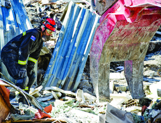 Members of the NZ and China Urban Search and Rescue Teams (USAR) work on the CTV site.