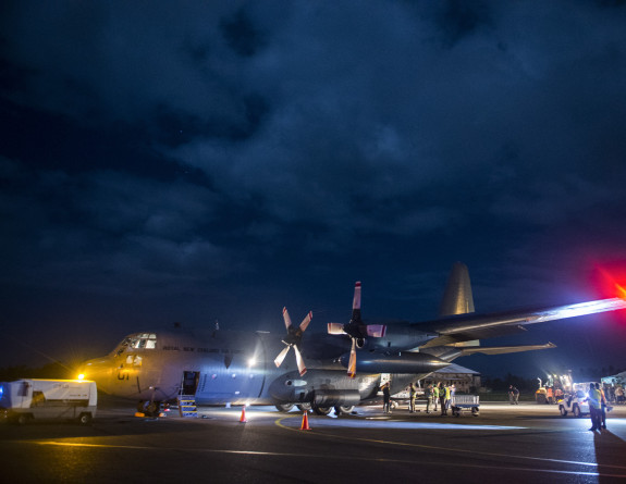 Aid supplies are unloaded from an RNZAF C-130 Hercules in Suva, Fiji.