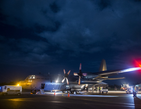 Aid supplies are unloaded from an RNZAF C-130 Hercules in Suva, Fiji.