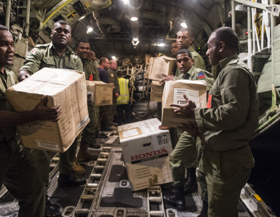Aid supplies are unloaded from an RNZAF C-130 Hercules in Suva, Fiji.