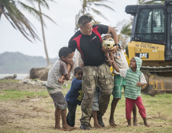 A soldier plays with local kids on the island of Vanua Balavu in the Northern Lau Group.
