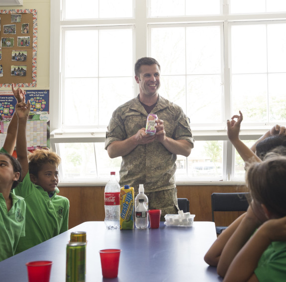 New Zealand Army dentist asks students a question during a class on Healthy lifestyles.