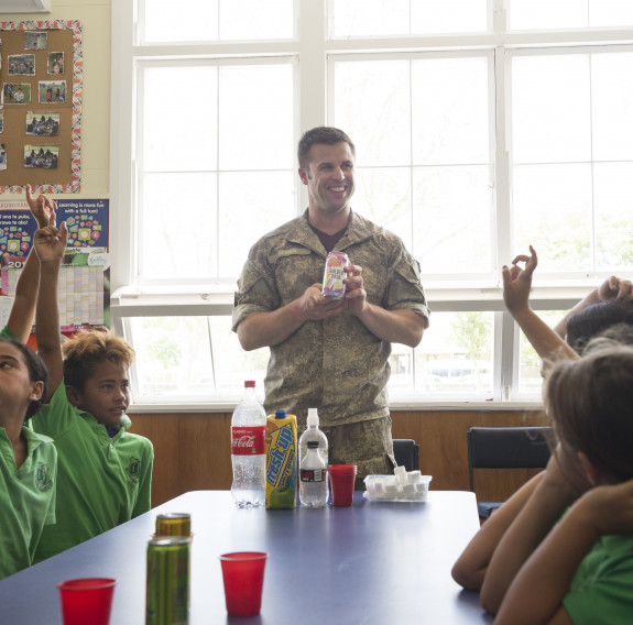New Zealand Army dentist asks students a question during a class on Healthy lifestyles.