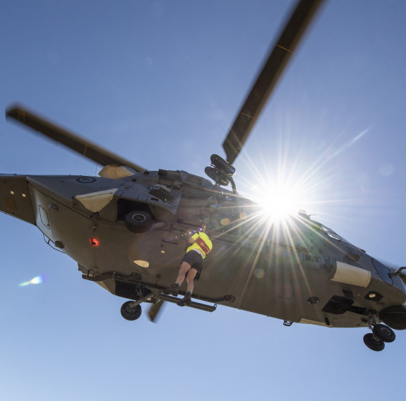 A search and rescue (SAR) team member winch from an NH90 helicopter during an exercise with No. 3 Squadron, NZ Police and NZ Land SAR at Turangi airfield.