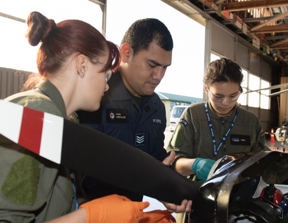 School to Skies participants assemble an aircraft with help from an Airmen