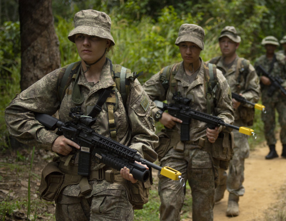 Our personnel in formation march in full gear in the Malaysian Jungle.