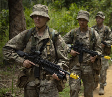 Our personnel in formation march in full gear in the Malaysian Jungle.