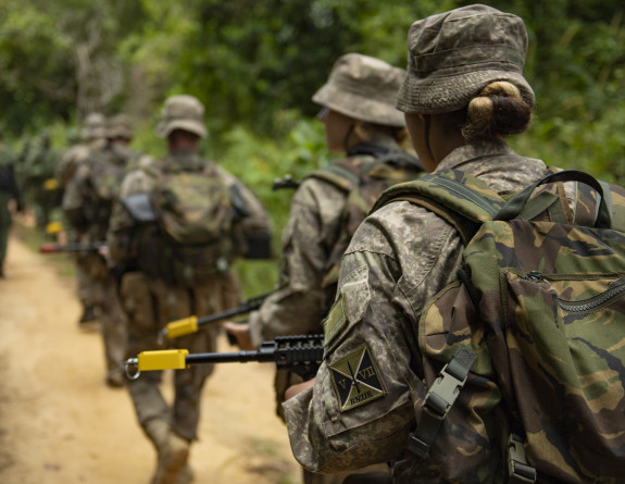 Our personnel in formation march in full gear in the Malaysian Jungle.