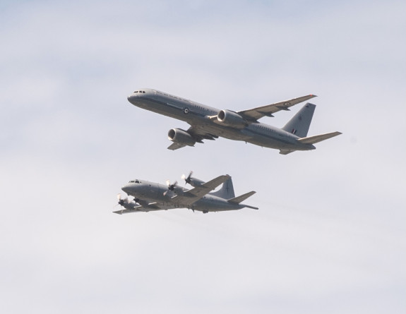 A worms eye view of an Orion aircraft (left) and Boeing aircraft (right) formation flying 