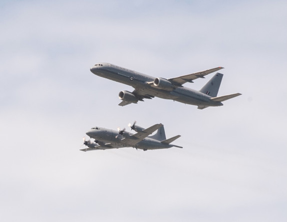 A worms eye view of an Orion aircraft (left) and Boeing aircraft (right) formation flying