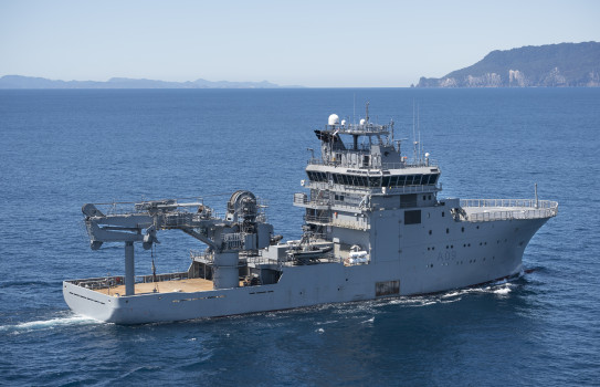 HMNZS Manwanui at sea, the large crane used for salvage operations is at the stern of the Ship.