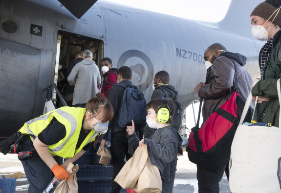 A child asks for an extra bottle of water from a member of the air movements team