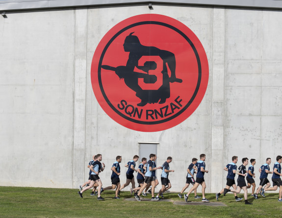 Air Force personnel running during a PT session outside the No. 3 Squadron hangar 