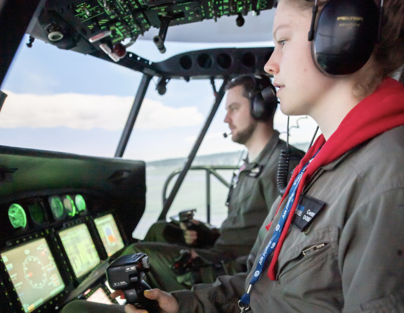 A Seasprite pilot teaches a School to Skies participant on a Seasprite helicopter simulator