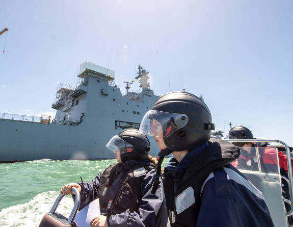 School to Seas participants on RHIB navigate through the harbour with HMNZS Canterbury near