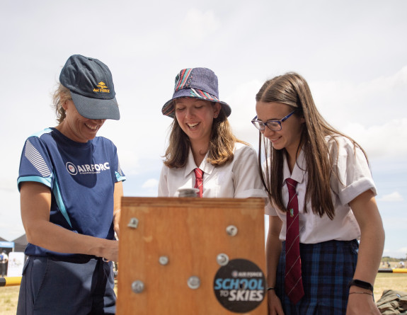 A member (left) of the school to skies on the road team takes two local school students through a tool box exercise during Wings over Wairarapa 2021.