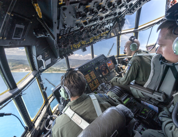 Air crew in the flight deck of the C-130H(NZ) bank toward Presidente Nicolau Lobato International Airport in Dili, Timor-Leste.