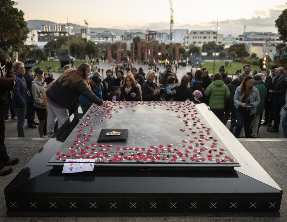 Members of the public lay poppies on the Tomb of the Unknown Warrior on Anzac Day in 2021.