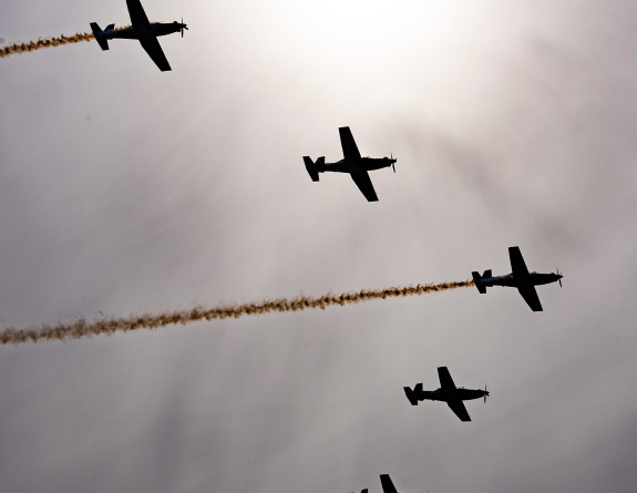 A five ship formation of Royal New Zealand Air Force T-6C Texan aircraft on a cloudy day 