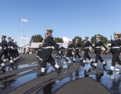 Officers and recruits march in formation on the parade ground during a graduation parade 