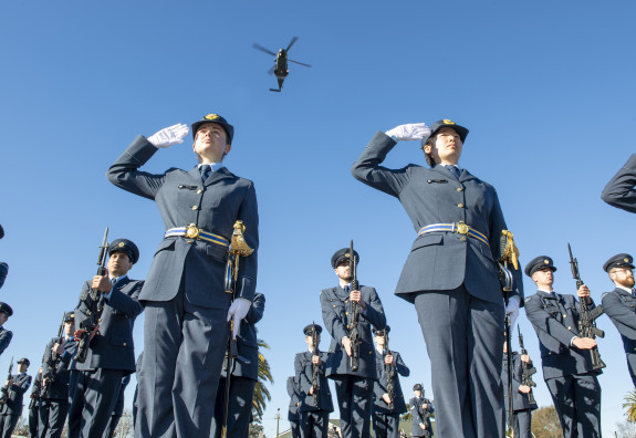 A Royal New Zealand Air Force NH90 helicopter from No.3 Squadron flies overhead Officer Cadets during their graduation parade.