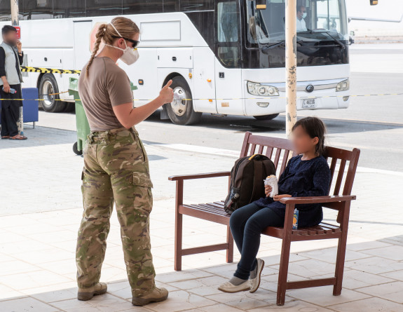 A New Zealand Army soldier reassures one of the young evacuees from Kabul outside the Evacuation Handling Centre.
