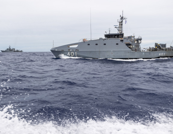 Two ships move through the ocean. 