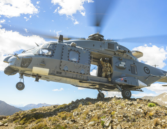 An NH90 helicopter lands on top of a mountain
