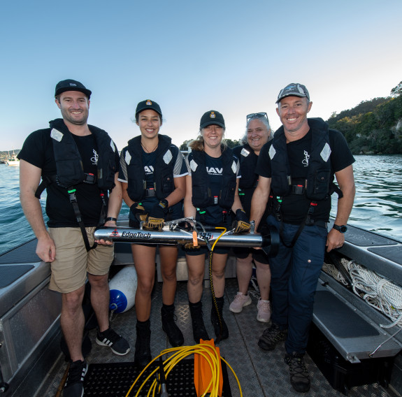 From left, Dr Kurt Bennett (Maritime archaeologist), AHSO Ana-Marie Conroy, AHSO Katie de Jong, Rebecca Cox (Manager of Mercury Bay museum) and Matthew Gainsford (Maritime archaeologist), with the side-scan sonar device.