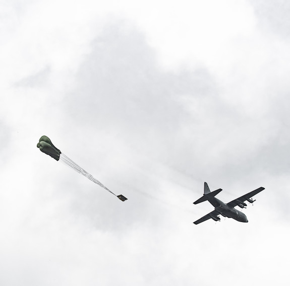 Cargo is dropped out the back of our Hercules above the drop zone on a cloudy day over Manawatū.