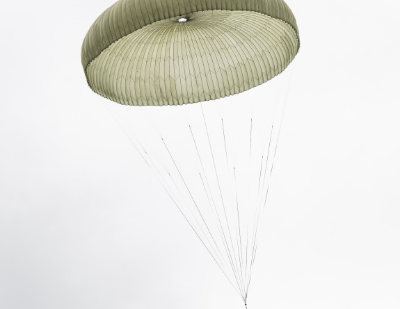 A pallet under parachute landing at the drop zone at Raumai Range in Manawatu on a cloudy day.