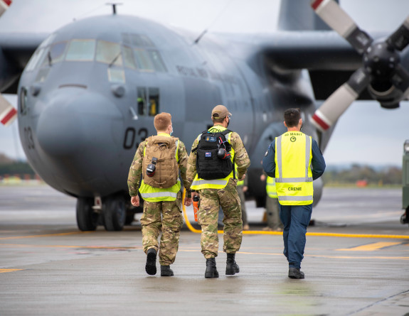 Royal New Zealand Air Force personnel prepare to board the Hercules aircraft. 