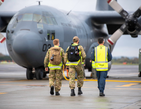 Royal New Zealand Air Force personnel prepare to board the Hercules aircraft.