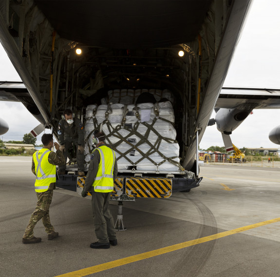 Medical supplies and soccer equipment are unloaded from a Hercules aircraft to deliver to Solomon Islands’ remote villages.